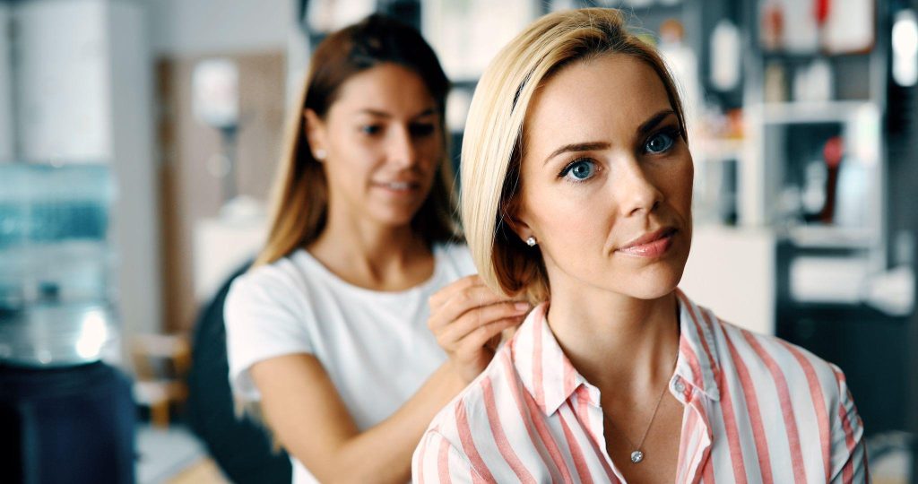 A licensed cosmetologist styling a client’s hair in a Wisconsin salon